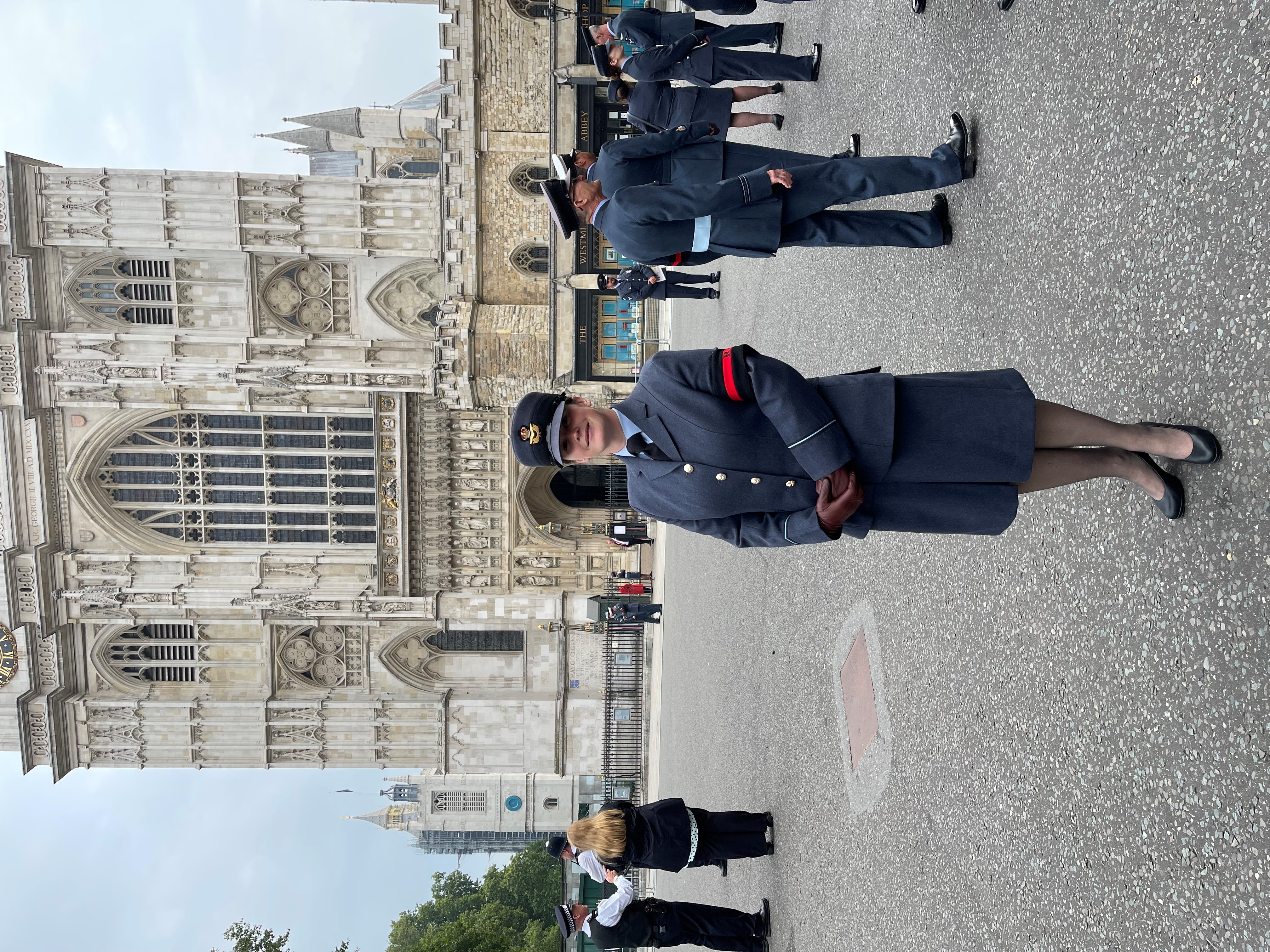 Personnel stand outside Westminster Abbey.